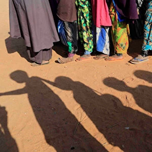 Somali internally displaced children queue before getting into a classroom at a school