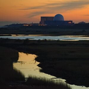 View across coastal wetland habitat at dusk, with Sizewell nuclear power station in distance, Minsmere RSPB Reserve