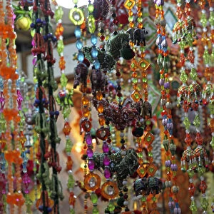 Asia, India, Delhi. Colorful strands of beads hang in market in Old Delhi
