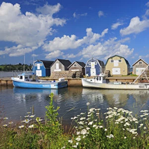 Canada, Prince Edward Island, New London. Fishing boats and sheds in coastal village