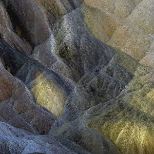 Colorful travertine slope with yellow and brown cyanobacteria, Mammoth Hot Springs, Yellowstone National Park, Wyoming