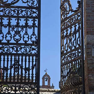 Italy, Tuscany, Montepulciano. The wrought iron gate leading to the cemetery near the Church of San Biaggio