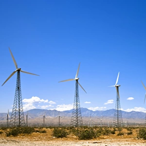 Palm Springs, CA, USA - Wind turbines in a desert landscape with rocky hills in the background