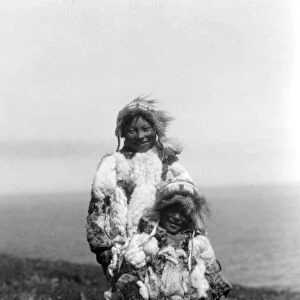 ALASKA: ESKIMOS, c1929. A young child and an older Eskimo wearing duck skin parkas