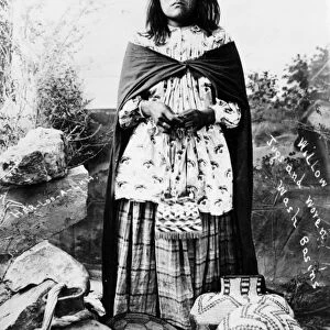 APACHE WOMAN, c1908. An Apache woman posed with willow jugs and woven wash basins. Photograph, c1908