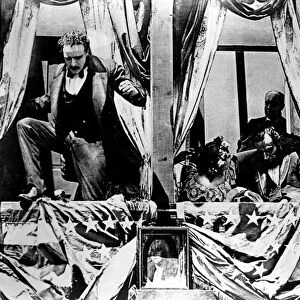 BIRTH OF A NATION, 1915. John Wilkes Booth jumps to the stage after having assassinated President Abraham Lincoln at Fords Theatre in Washington D. C. Scene from D. W. Griffiths film Birth of a Nation, 1915