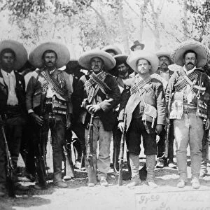 FRANCISCO PANCHO VILLA (1877-1923). Mexican revolutionary leader. Photographed wearing bandoliers with his military staff during the Mexican Revolution, c1913