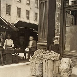 HINE: CHILD LABOR, 1908. Eleven-year old girl selling baskets in front of a saloon