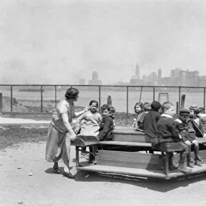 IMMIGRANTS: ELLIS ISLAND. Immigrant children at play outside the main hall, with
