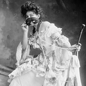 MASQUERADE BALL, c1908. A masked woman at a masquerade ball. Photograph, c1908