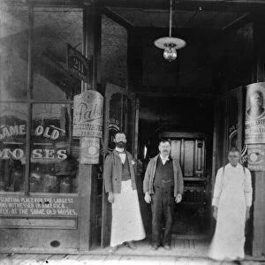 Moses Weinberger (center) with bartenders Mack O Brien (left) and Ike Reed at the entrance to the Same Old Moses Saloon at 211 West Harrison Avenue in Guthrie, Oklahoma, operated by Weinberger since 1890 as the first legal saloon in the Oklahoma Territory. Photographed c1900