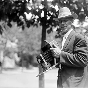PHOTOGRAPHER AND CAMERA. Mr. A. Leonard with his camera. Photographed by Harris and Ewing