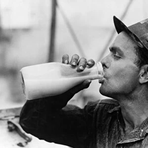 TEXAS: OIL WORKER, 1939. An oil field worker drinking a bottle of milk during lunch at Kilgore