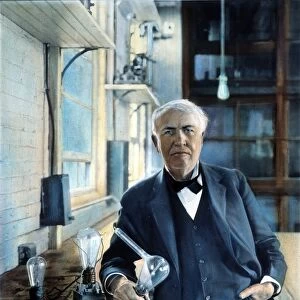 THOMAS EDISON (1847-1931). American inventor. Photographed with his Edison Effect lamps in his West Orange, New Jersey, laboratory in 1915. Oil over a photograph