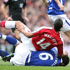 Theo Walcott (Arsenal) is tackled by Liam Ridgewell (Birmingham)