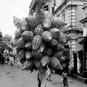 Asia, india, bombay, vendor of baskets, 1952