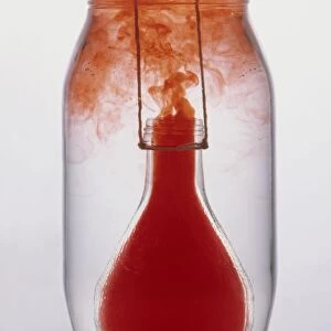 Bottle containing hot water (coloured red), lowered into jar of cold water, hot water rising to top of jar