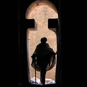 Man entering Bet Medhane Alem church in Lalibela