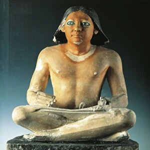 Painted limestone statue of seated scribe with papyrus from Saqqara