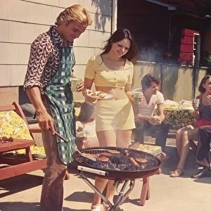People having a backyard barbecue