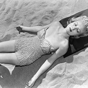 Woman Sun Bathing At The Beach
