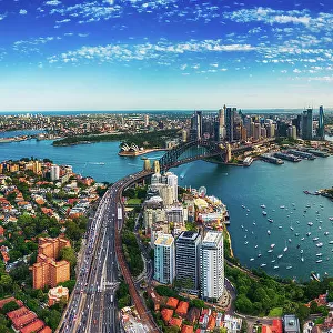 Panorama Aerial view Scene of Crowded Traffic over Express way heading to Sydney Harbour Bridge with Opera House, Lavender bay with many Yacht and Circular Quay