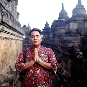 Asian man in traditional dress posed at Borobudur temple
