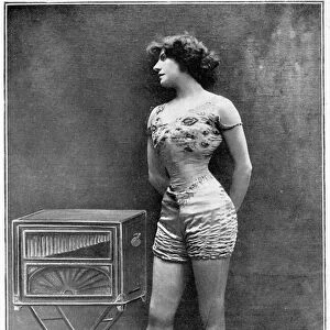 The actress Polar posing beside a barbarous organ, wearing the costume she wore in