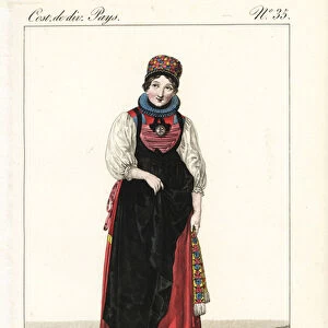 Betrothed girl of the Canton of Fribourg, Switzerland, 19th century. She wears a colourful cap, ruff, bodice, chemise, apron and petticoats. On her bosom is a gold box called a lamb of god