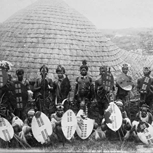 Group Portrait of Zulu Warriors outside a hut, c. 1875 (albumen print)