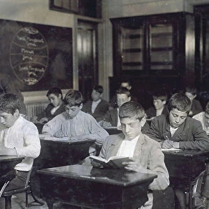 Image shows a class of immigrants in a night school, 1909