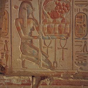 Kneeling figure presenting baskets of food, from the Temple of Ramesses II, New Kingdom