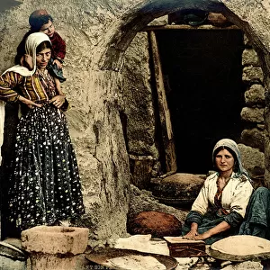 Lebanese women making bread in front of their house, c. 1880-1900 (photochrom)