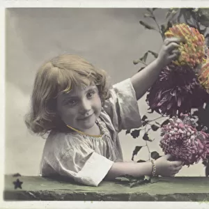 Little girl with flowers (colour photo)