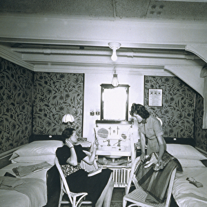 Maid helping her mistress undress aboard the RMS Scythia (b / w photo)