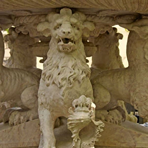 Mythical horned Lion Atlantes at the base of a fountain