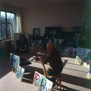 Pablo Picasso (1881-1973) in his studio surrounded by his series