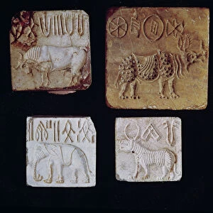 Four seals depicting a bull, a rhinoceros, an elephant and a tiger with pictographic