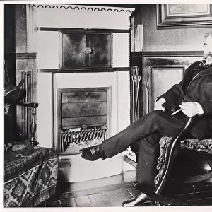 Stephane Mallarme (1842-98) seated by the fireplace at his home on Rue de Rome