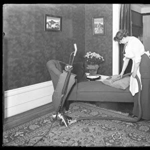 Unidentified woman demonstrating the use of the Apex vacuum cleaner