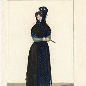 Woman of Madrid, Spain, 19th century. She wears the traditional black mantilla veil trimmed with blue check and tassels, black basquina dress, and carries a fan