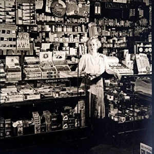 Woman shopkeeper in a tobbaconists (b / w photo)