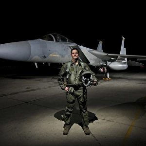 A U. S. Air Force pilot stands in front of a F-15C Eagle