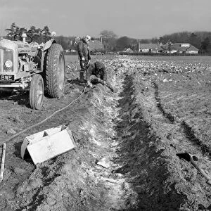 Contractors setting explosives in a trench in Firbeck, near Rotherham, 1962. Artist