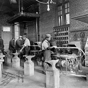 Young men training in blacksmithing at Hampton Institute, Hampton, Virginia, 1899 or 1900. Creator: Frances Benjamin Johnston