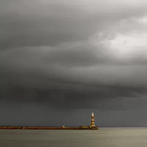 Lighthouse At The End Of A Pier With Dark Storm Clouds Overhead; Sunderland, Tyne And Wear, England
