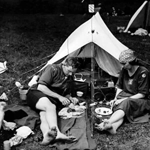 Campers enjoying a meal whilst listening to a wireless radio set. June 1924 P000021