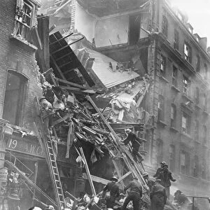 Damaged buildings are inspected after air raid in London. 5th December 1941