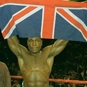 Frank Bruno holds up the union jack after his third round defeat at the hands of Mike