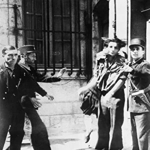 A French woman slaps a captured Gestapo agent who was the cause of her husband being